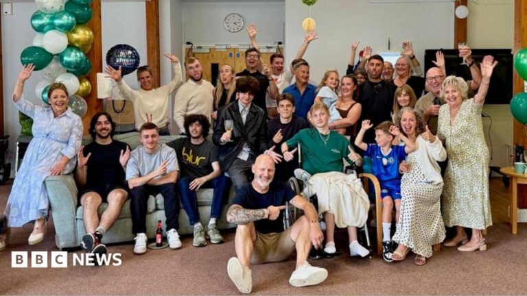 Zane’s Warriors take part in Moonlight Walk in teenager’s memory Zane, his family, friends and hospice staff pose for a photo among celebrate his 19th birthday among green, white and gold balloons