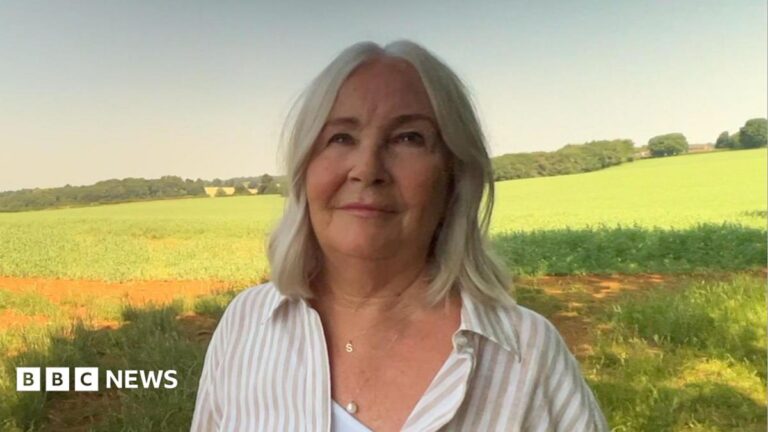 A selfie photo of Judith Dunn smiling at the camera