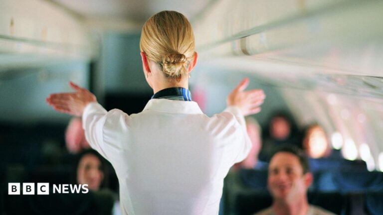 Radiation link in flight attendant’s breast cancer, French court finds An air stewardess facing away from the camera shows passengers on a jet the emergency exist during a safety briefing. She is wearing a white shirt and her blonde hair is in a tight bun