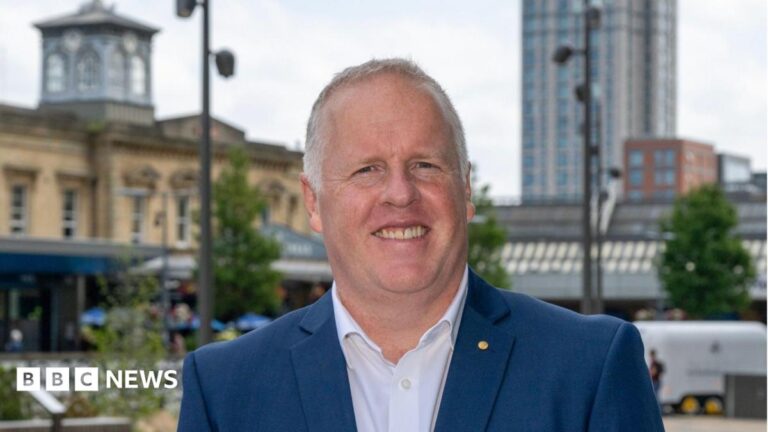 Reading’s Rutherford Cancer Centre to reopen after four years Mark Middleton, a middle aged white man with short grey hair, smiles at the camera. He is wearing a blue suit jacket and a white shirt with the top button undone. He is stood in front of Reading town centre.