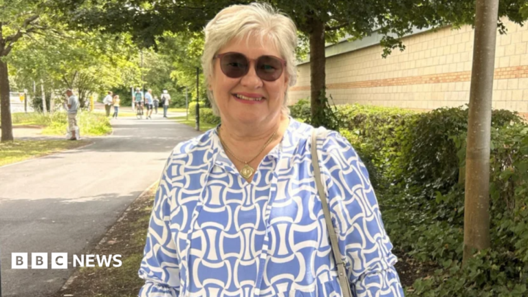 York woman praises clinical trial which helped her survive cancer A woman with short grey hair and a blue fleece, stands in front of a mountain with a man, a woman in a purple jacket, and two small children.