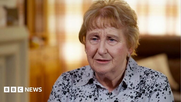 ‘I’ve been butchered’: Women on trauma after unnecessary mastectomies Pam Brown wearing a patterned shirt while looking wistfully to camera as she gives an interview indoors.