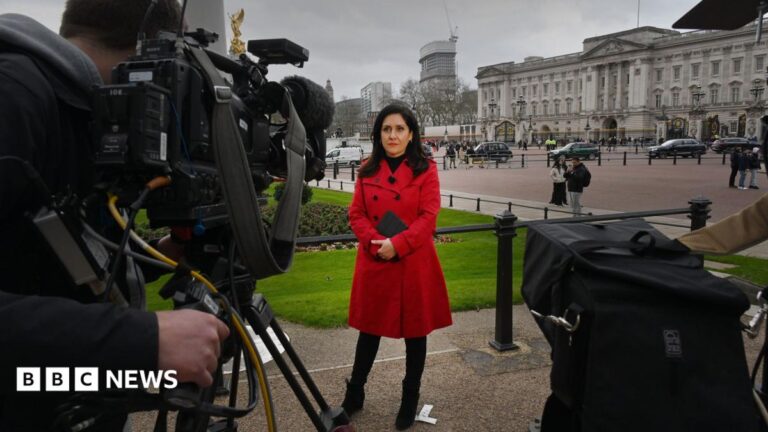 Maryam Moshiri stand in a black coat. The Vatican is in the background